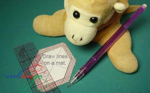 Leave the shapes on the cutting mat when you draw the lines.